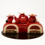 With Pistachio Dacquoise, Pistachio Crunch, Raspberry Confit, White Chocolate Pistachio Mousse, Red Mirror Glaze, Mini Meringues & Berries